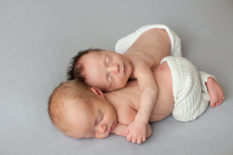 newborn twins snuggling