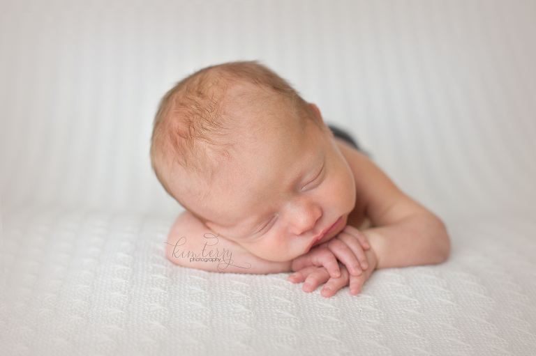newborn head on hands pose