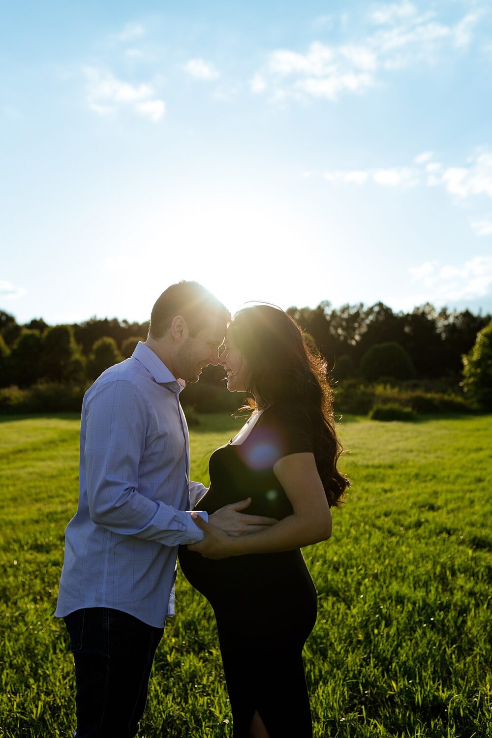 pregnant woman and man with sunflare